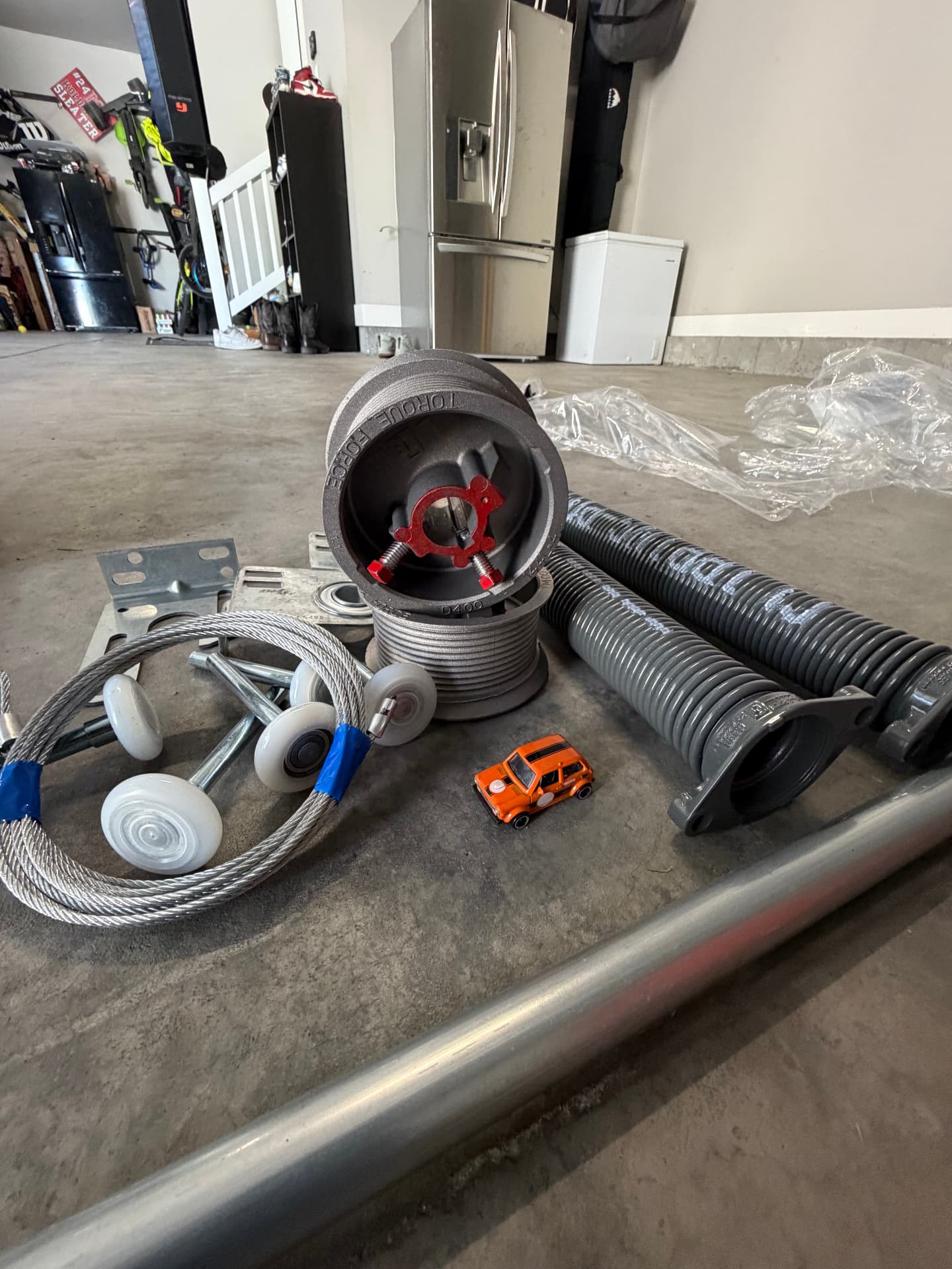 New torsion springs, cables, rollers and drums ready for installation