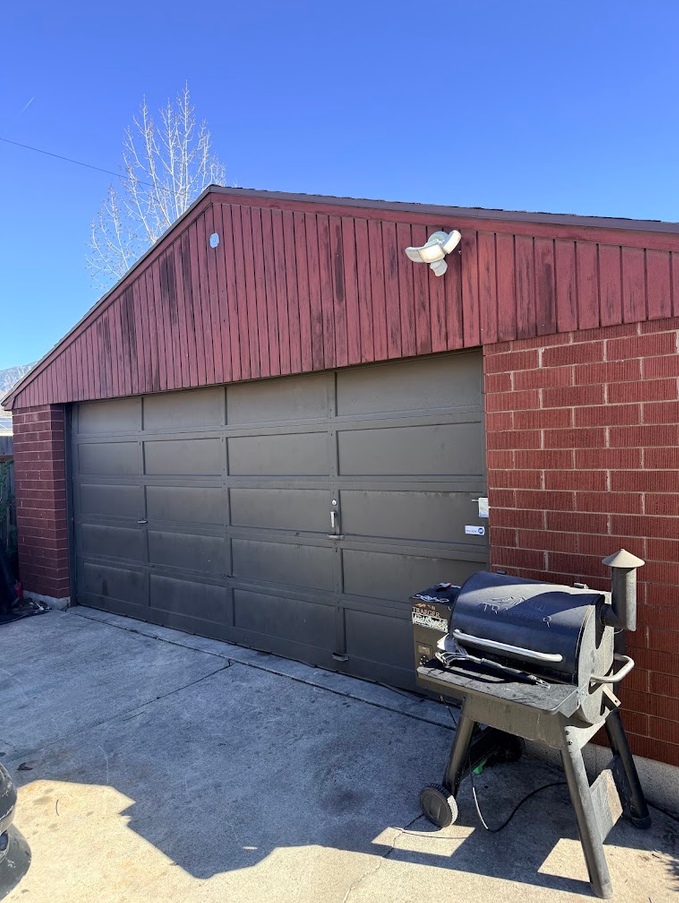 Repainted steel garage door on a brick Utah County home