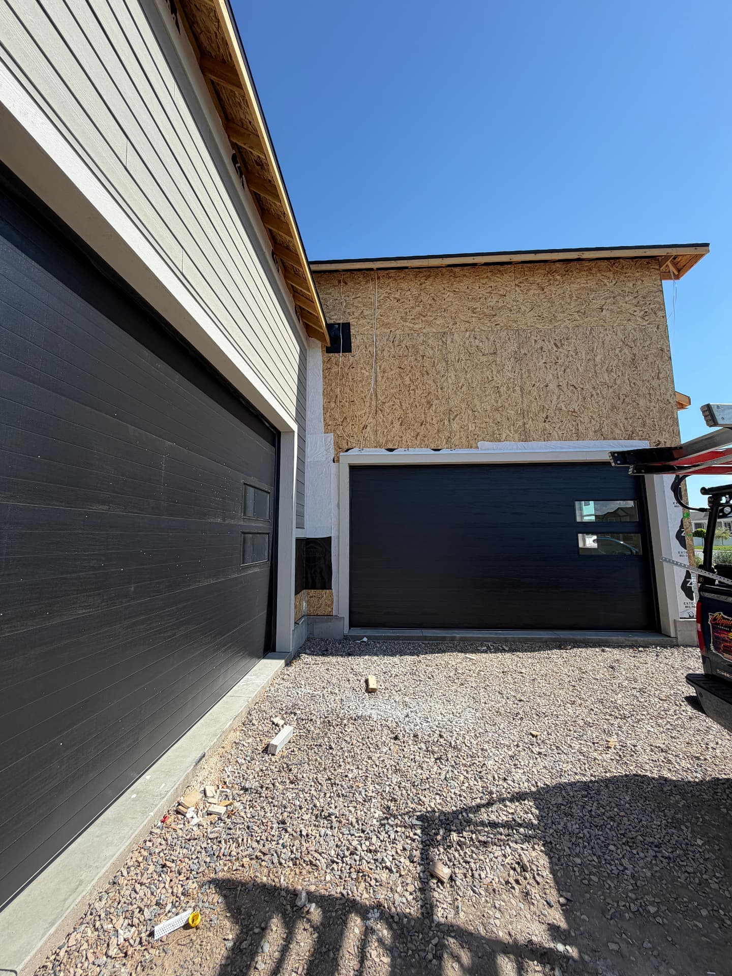 Modern black garage doors installed on a new Utah County home